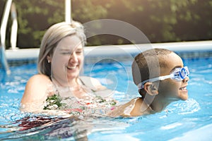 Mother and baby swim in the pool