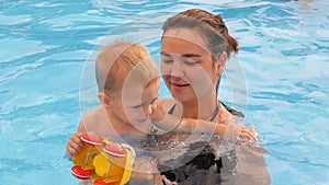 Mother and baby swim in the pool.