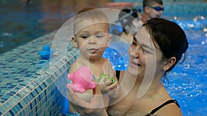 Mother and baby swim in the pool.