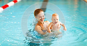 Mother and baby swim in pool