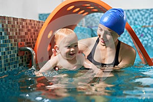 Mother with baby in swimming pool training