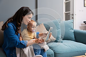 Mother, baby and tablet on sofa watching educational video online on streaming service in home. Love, family time and woman with