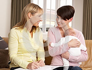 Mother With Baby Talking With Health Visitor