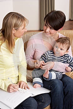 Mother With Baby Talking With Health Visitor photo