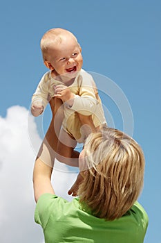 Mother with baby under blue sky