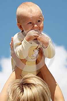 Mother with baby under blue sky