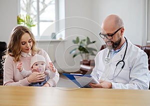 Mother with baby visiting pediatrician