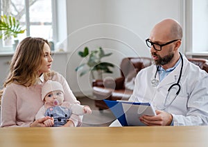 Mother with baby visiting pediatrician