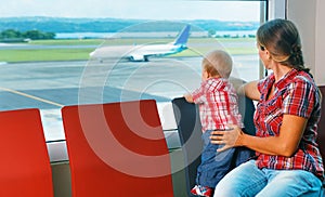 Mother with baby wait for boarding to flight in airport