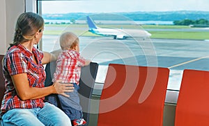 Mother with baby wait for boarding to flight in airport