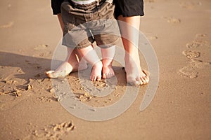 Mother and baby walking on beach