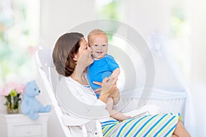 Mother and baby in white bedroom