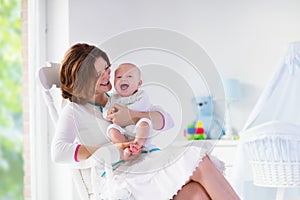 Mother and baby in white bedroom