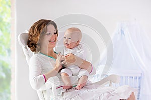 Mother and baby in white bedroom