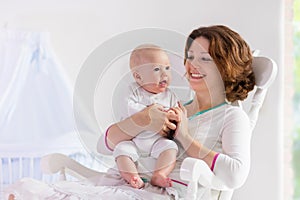 Mother and baby in white bedroom