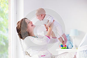 Mother and baby in white bedroom