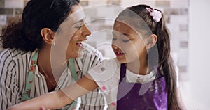 Mother, baking, and daughter learning to bake cookies in the kitchen in a happy family home prepare bakery food. Woman