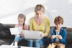 mother and beautiful children using digital devices