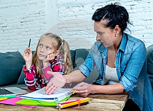 Mother becoming frustrated with daughter whilst doing homework sitting on sofa At home in learning difficulties homework parenting