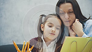 Mother becoming frustrated with daughter whilst doing homework sitting at the table at home in learning difficulties