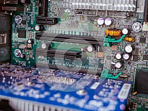 Mother board in focus on old dusty opened personal computer