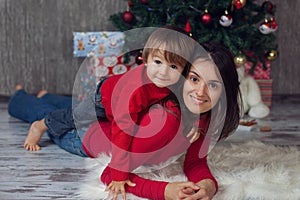 Mother with boy in front of a christmas tree