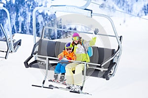 Mother with boy lifting on ski lift