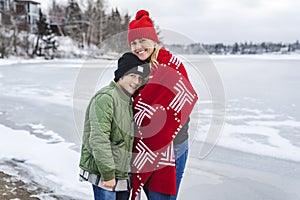 mother and boy in winter season on lake border