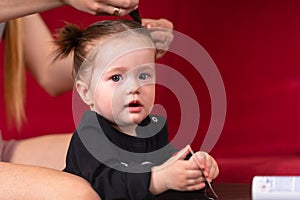 Mother braids her baby daughters hair