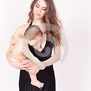 Mother breast feeding a cute baby. Newborn girl.