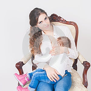 Mother breast feeding a cute baby. Newborn girl.