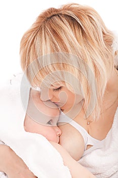 Mother breast feeding her newborn baby girl