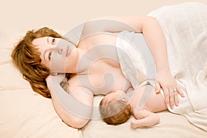 Mother is breast feeding newborn baby and dreami