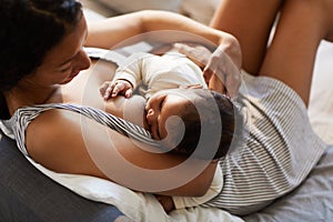 Mother breastfeeding baby in comfortable position