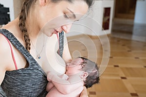 The mother is breastfeeding the baby. mother breastfeeds and hugs the baby, close-up breast. Mom breastfeeds her newborn baby.