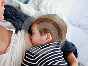 Mother is breastfeeding her baby. close-up. natural nutrition. Young mother breastfeeding her newborn baby boy at home