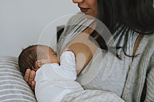 Mother breastfeeding her baby with love