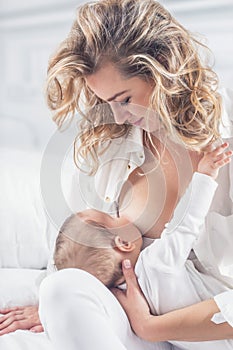 Mother breastfeeding her little baby in her arms