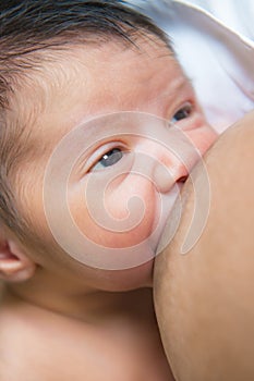 Mother breastfeeding her newborn baby