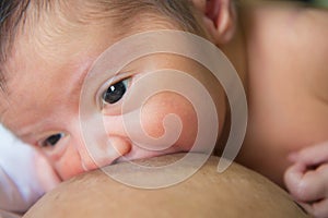 Mother breastfeeding her newborn baby