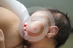 Mother breastfeeding her newborn baby photo