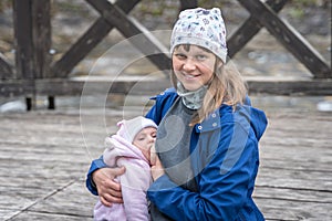 Mother breastfeeding her newborn baby girl in the park