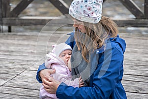 Mother breastfeeding her newborn baby girl in the park