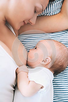 Mother breastfeeding newborn baby child