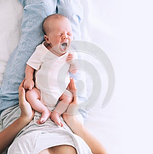 Mother breastfeeding newborn baby at home.