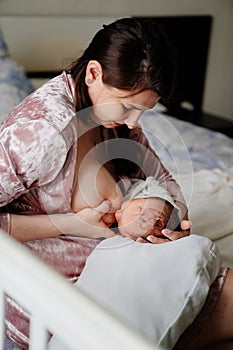 Mother breastfeeds newborn baby. naturalness and convenience of breastfeeding.