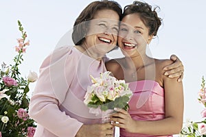 Mother and Bride with bouquet outdoors (portrait) photo