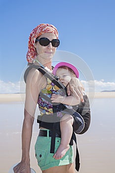 Mother carrying baby in rucksack