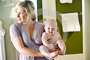 Mother carrying cute chubby baby photo