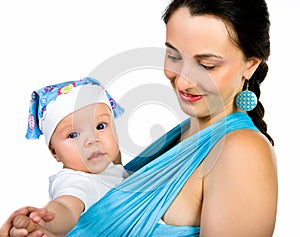 Mother carrying her baby in a sling